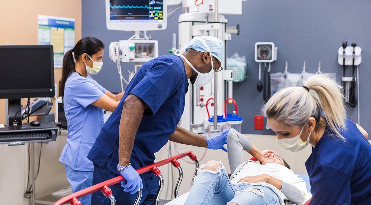 Trauma team stabilizes female patient in emergency room