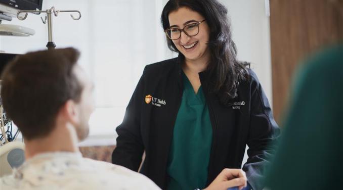 Woman doctor holding patient hand