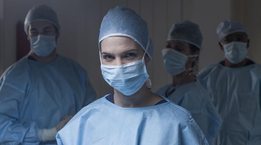 A group of doctors in masks and scrubs