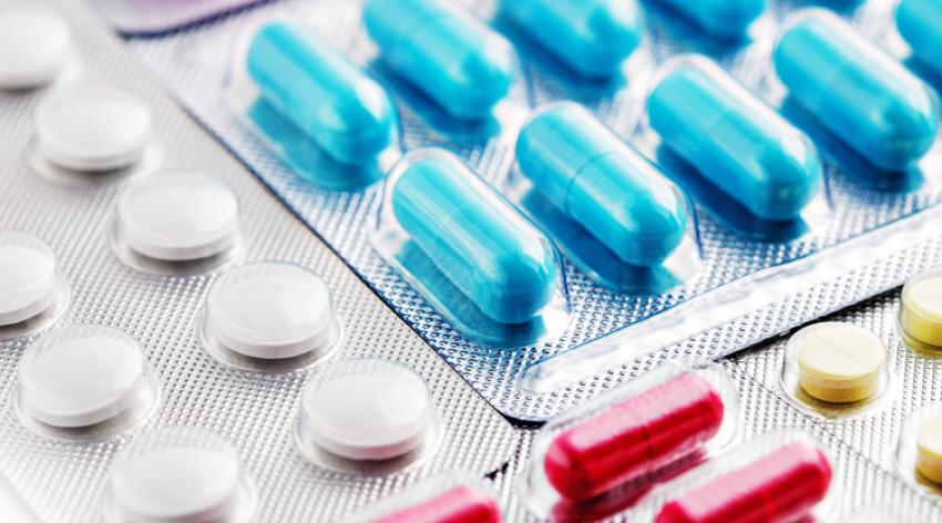 Heap of medical pills in white, blue and other colors