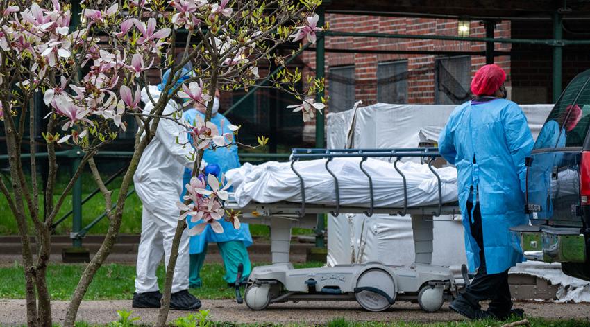 Staffers at Kingsbrook Jewish Medical Center in Brooklyn, New York, transport a deceased patient to a refrigerated truck that the center had to use for the bodies of COVID-19 victims during a surge in the spring of 2020.
