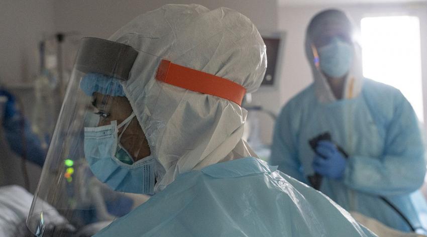 A medical staff member checks an electrocardiograph while performing endoscopy on a patient suffering from COVID-19 in the COVID-19 intensive care unit at the United Memorial Medical Center on November 25, 2020 in Houston, Texas.