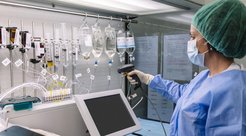 A researcher in a lab scans lab equipment
