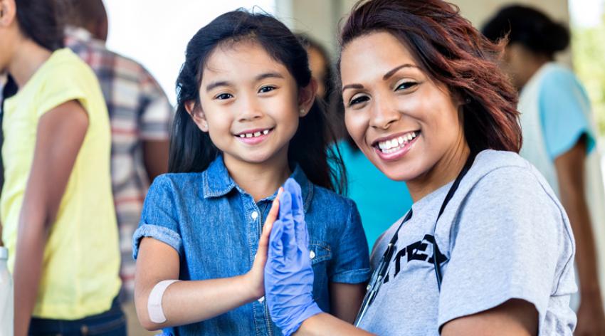 Female nurse volunteering at health fair