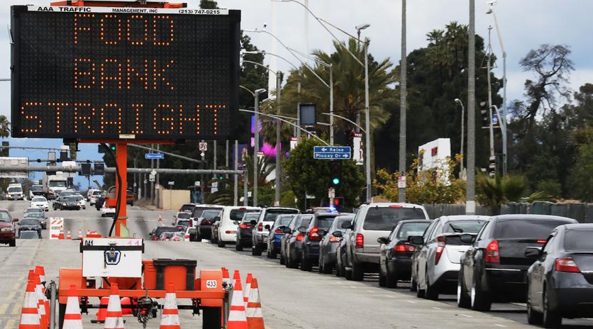 Cars line up at a free groceries distribution in observance of Good Friday for those impacted by the COVID-19 pandemic on April 10, 2020 in Inglewood, California.