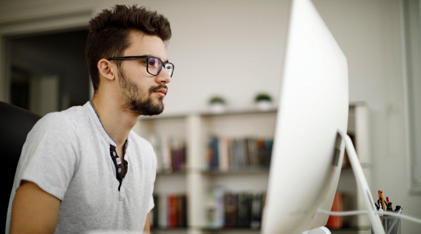 person at computer wearing glasses