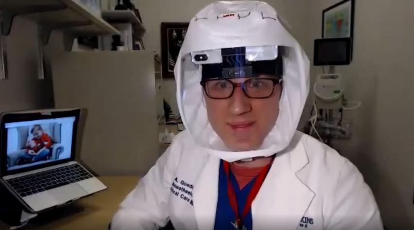 Johns Hopkins Medicine intensive care unit physician Lee Goeddel, MD, MPH, wears a cellphone underneath his protective hood so remote students can follow along live during rounds
