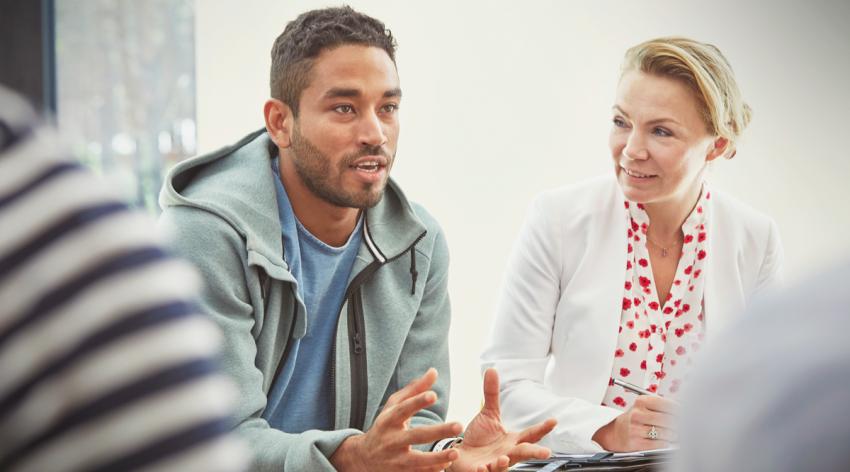 Man talking in group therapy session