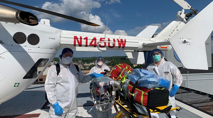 A University of Wisconsin Med Flight helicopter team prepares to transport a patient with profound respiratory failure from COVID-19