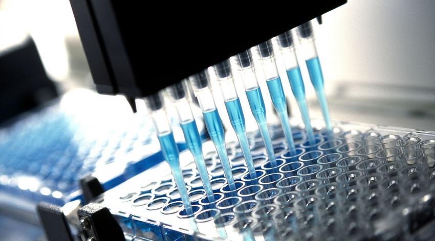 A row of pipettes in a machine