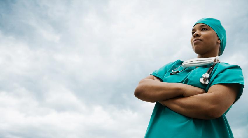 A female doctor standing with arms crossed