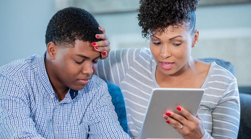 A mother and son have a telemedicine visit with a doctor