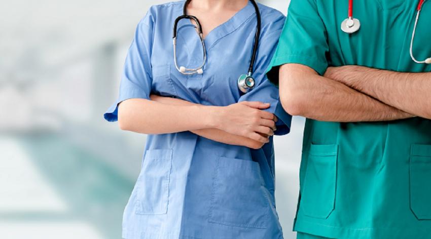 Two doctors stand with their arms crossed. 