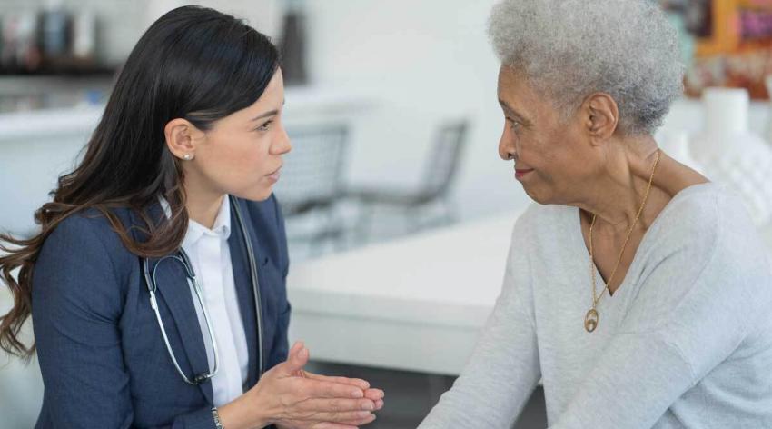 A female doctor talking to a female patient