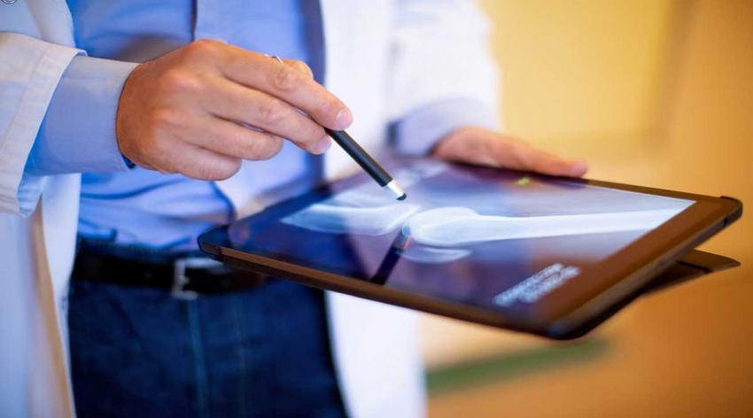 doctor holding tablet