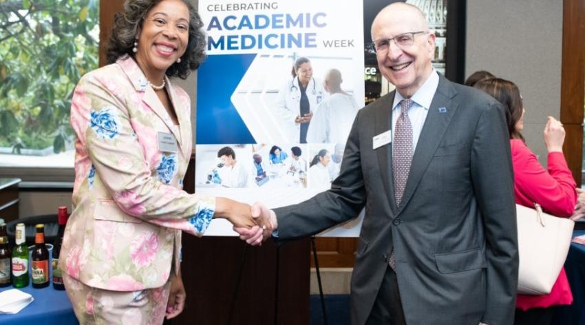 AAMC Chief Public Policy Officer, Danielle Turnipseed and AAMC President and Chief Executive Officer, David Skorton pose for the camera while shaking hands