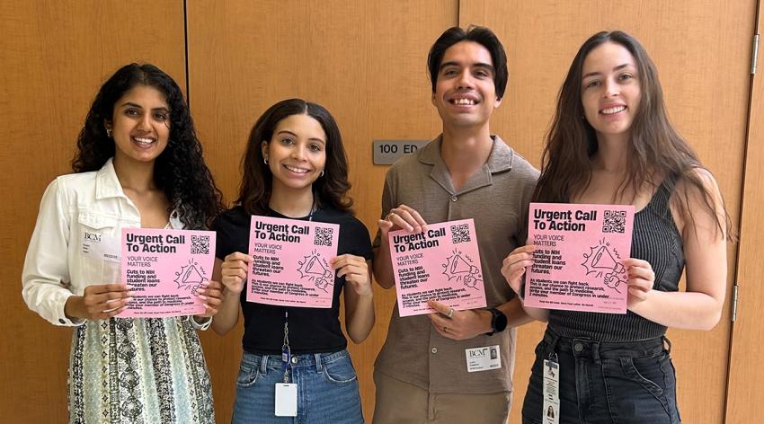 Students pose with flyers about loans
