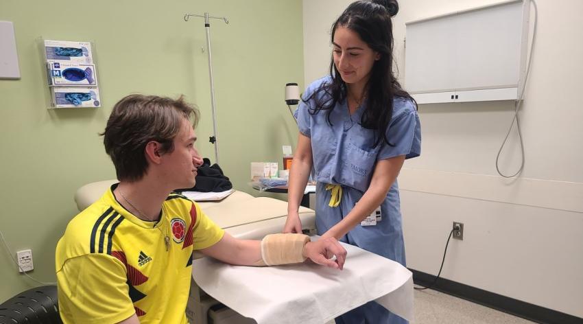 woman practicing medical procedures on man