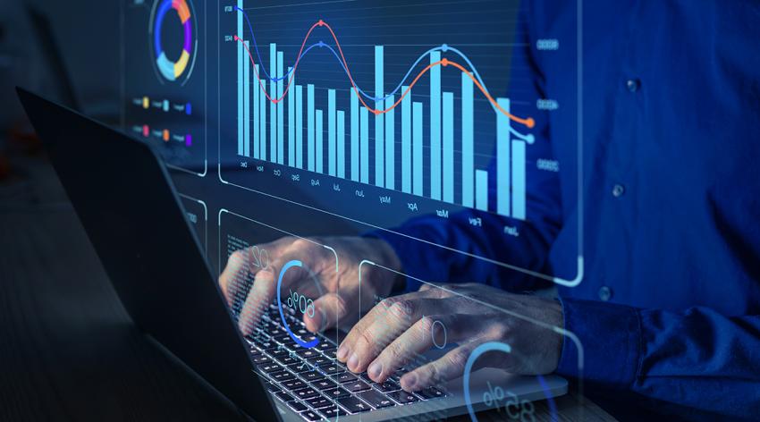 Data analyst working on business analytics dashboard with charts, metrics and KPI to analyze performance and create insight reports for operations management.