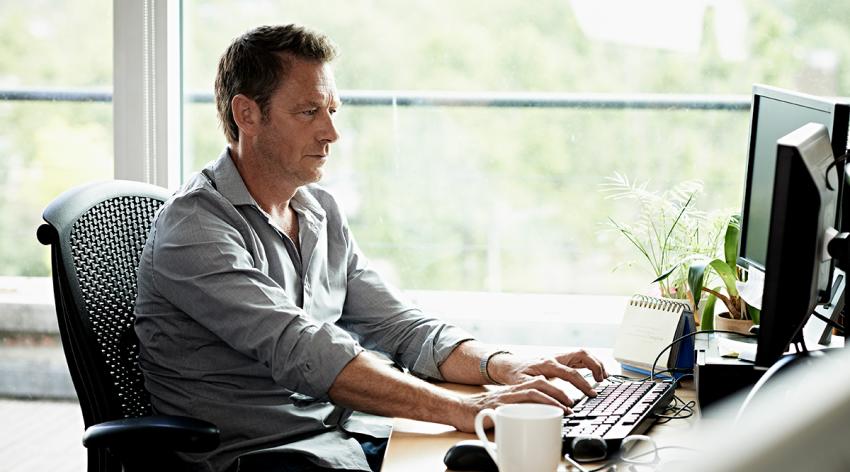 Businessman working on computer in in a modern office