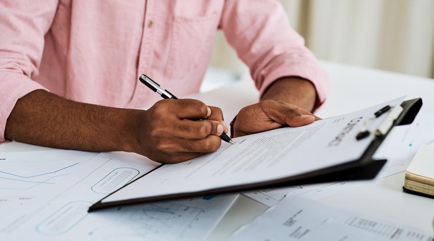 Businessman filling in paperwork in an office