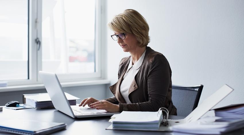 Businesswoman using laptop in office