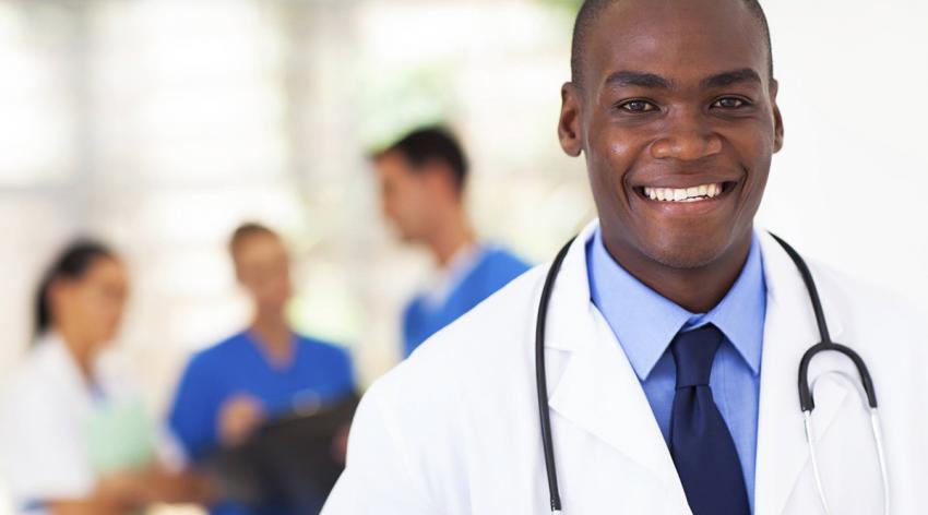 A close-up of a doctor wearing a white coat with a stethoscope