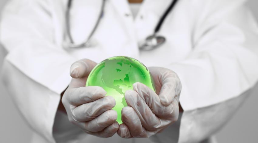 Doctor holding a green globe.