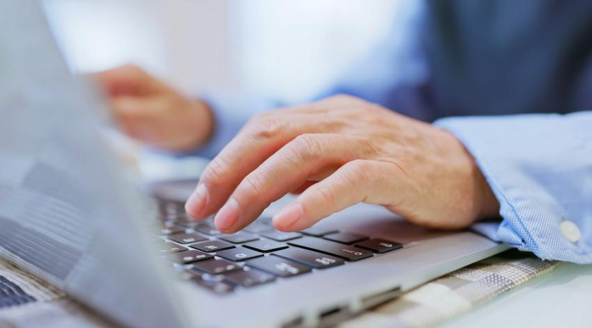 Asian elderly man use computer - closeup side view on his hands