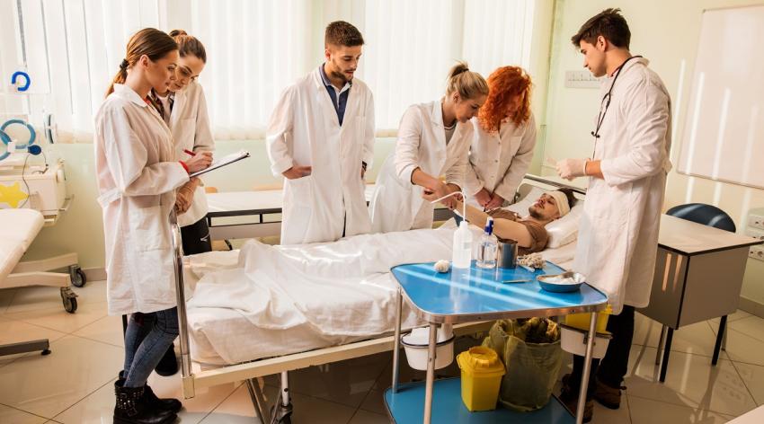 Large group of medical students learning during the practice in medical school