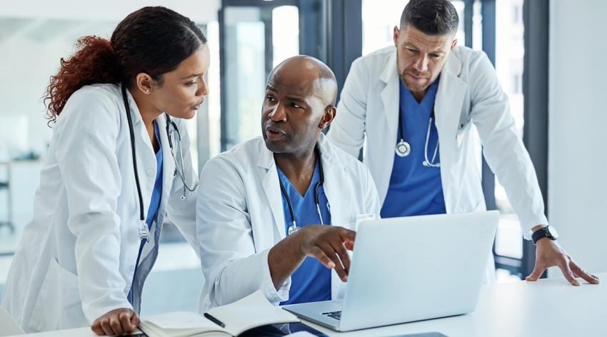 A female and two male physicians in a discussion