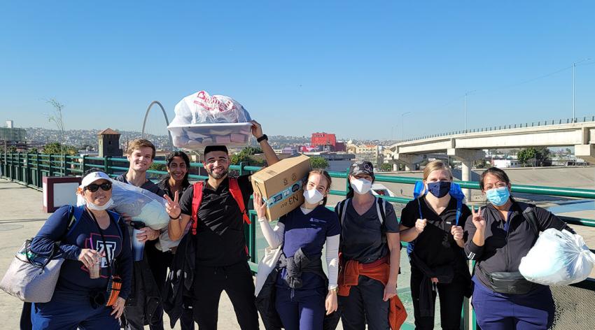 University of Arizona College of Medicine - Phoenix volunteers carry donations for Refugee Health Alliance in Tijuana, Mexico.