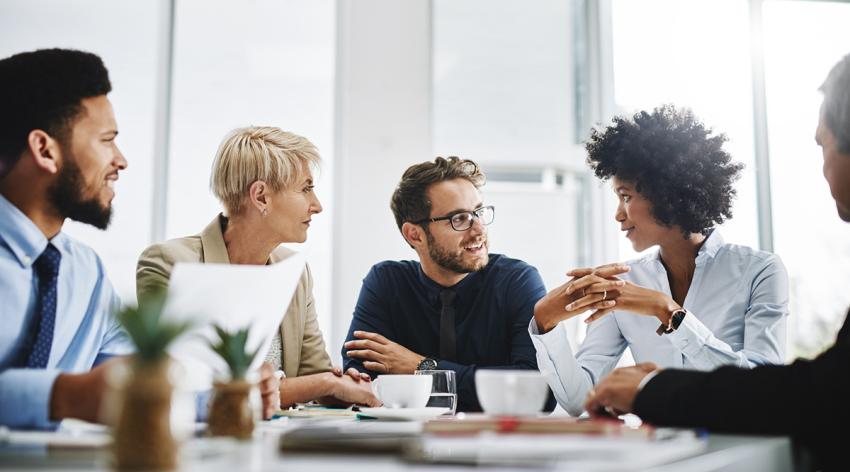 A diverse group of businesspeople sitting together and having a meeting in the office