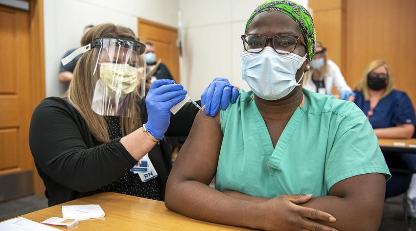 Mercy Dickson, MD, MBA, a third-year emergency medicine resident, gets one of the first COVID-19 vaccinations at the Ohio State University Wexner Medical Center on Dec. 14.