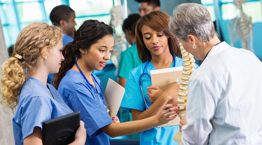 Medical school professor using model to teach nursing students