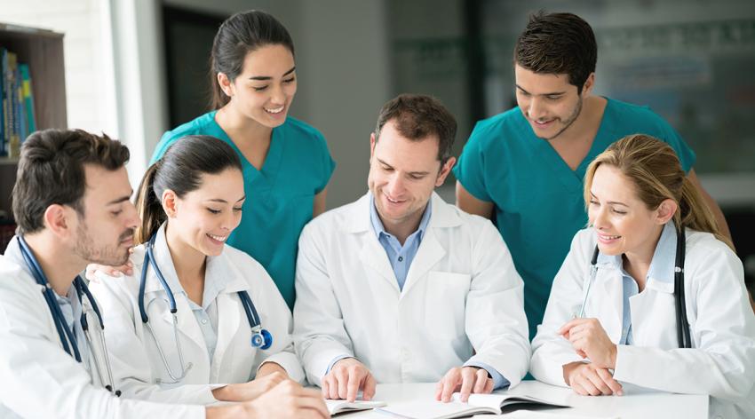 Medical staff in a meeting at the hospital talking and looking at documents