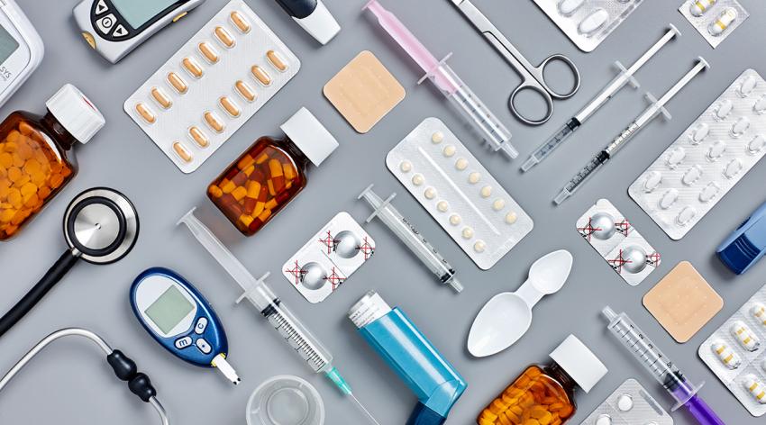 Flat lay of various medical supplies on gray background