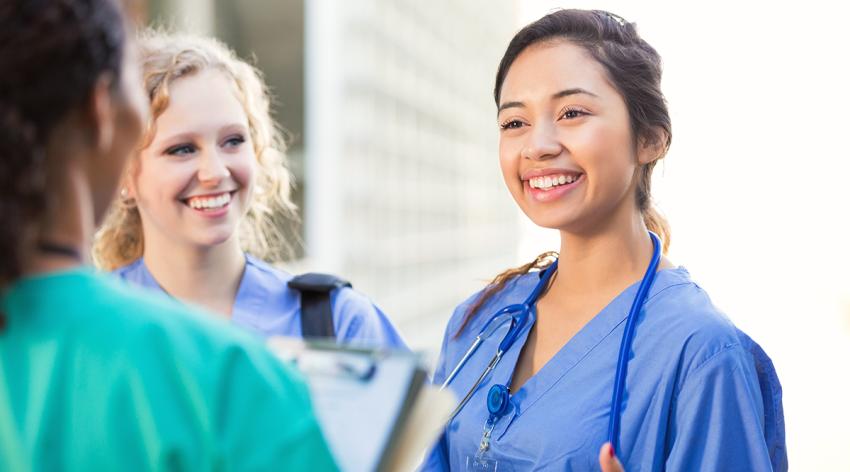 Nursing students talking together on college campus