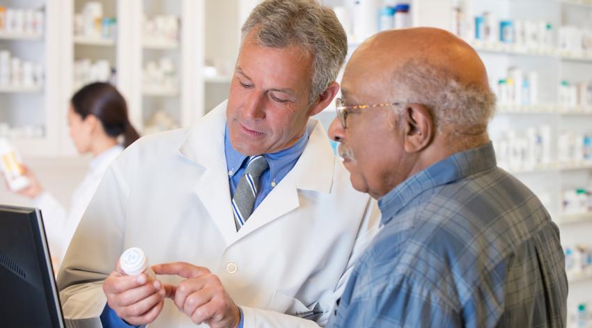 Pharmacist talking to customer about prescription