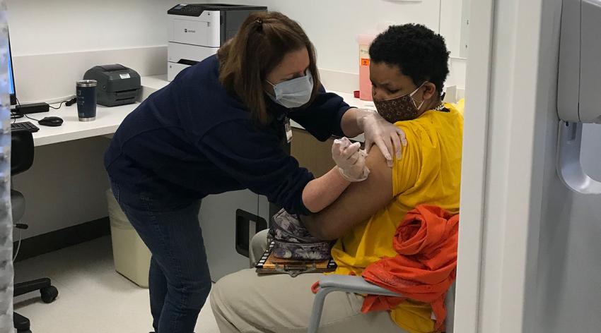 Jane Tobias, DNP, RN, MSN, gives a patient a COVID-19 vaccine at an April 3 event in Philadelphia that Jefferson Health designed to meet the needs of people with intellectual disabilities.