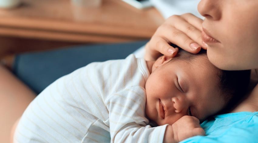 Baby sleeping on mother's chest