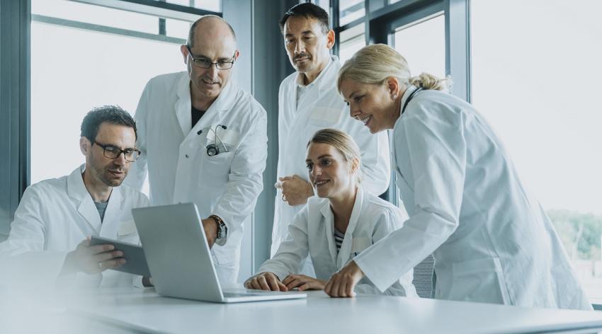 Team of doctors and scientist using laptop while working at office