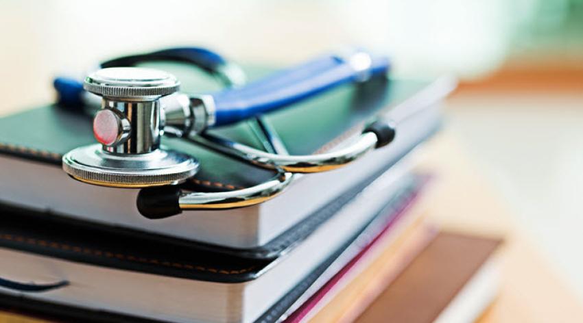 Image of a stack of books with stethescope