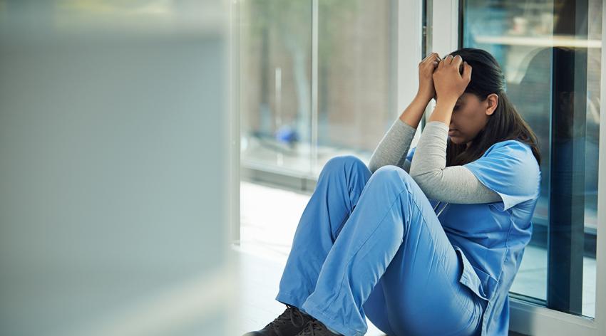 woman with scrubs sitting on the floor