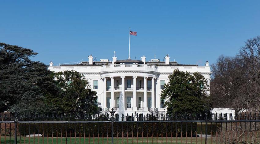 The White House with a blue sky behind it