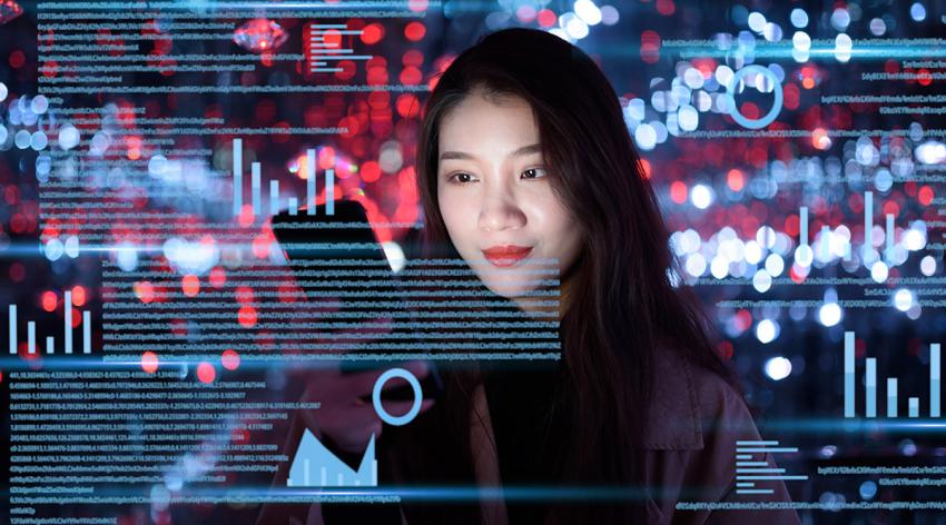 Young woman uses mobile phone on virtual visual screen at night