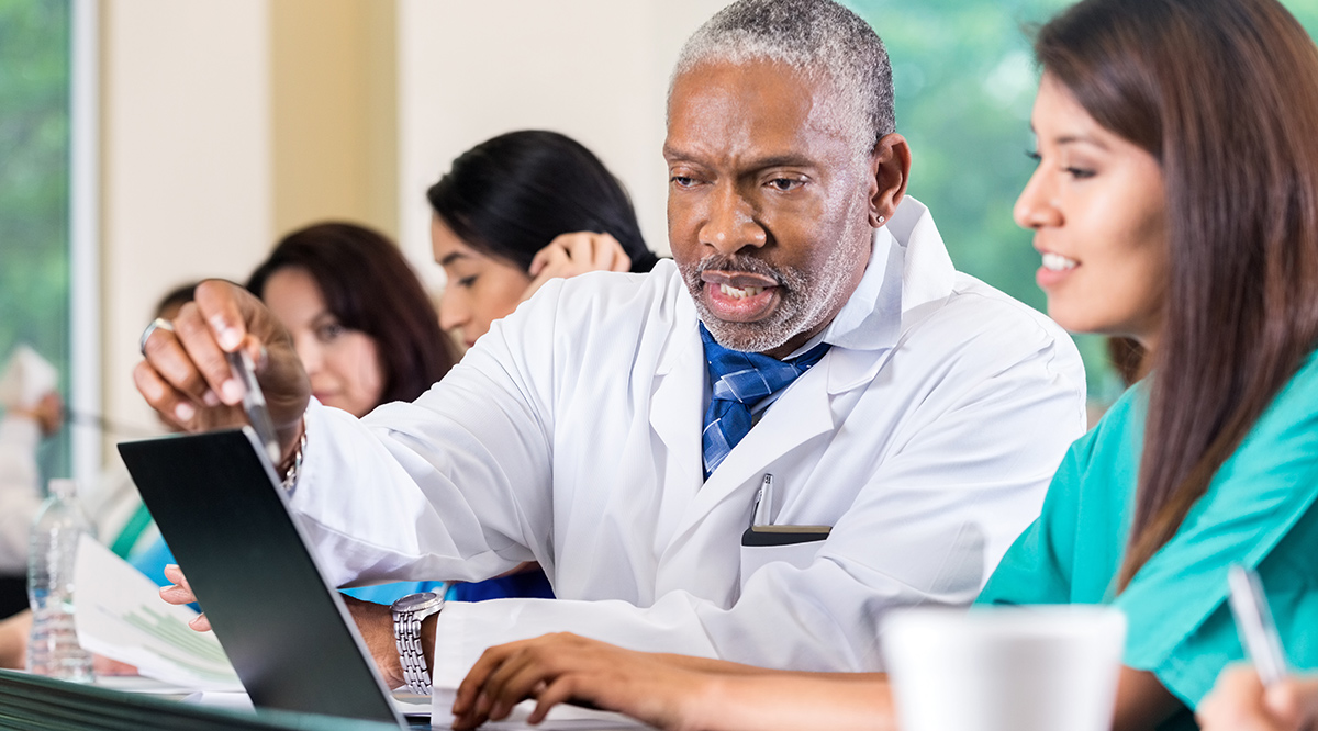 Senior professor assisting medical student