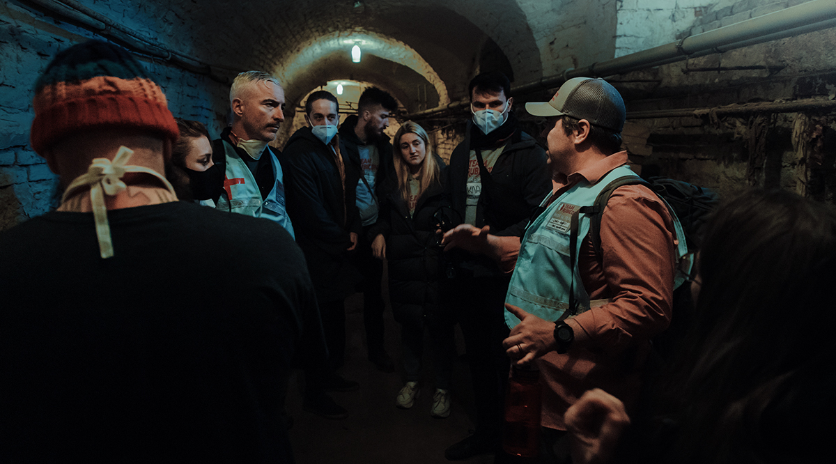 Volunteers with the nonprofit disaster organization Team Rubicon take shelter during an air raid in Western Ukraine in March.