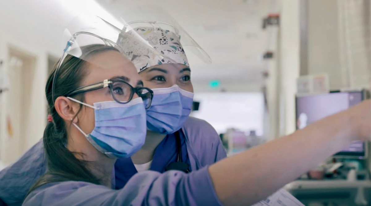 Two nurses looking at a screen