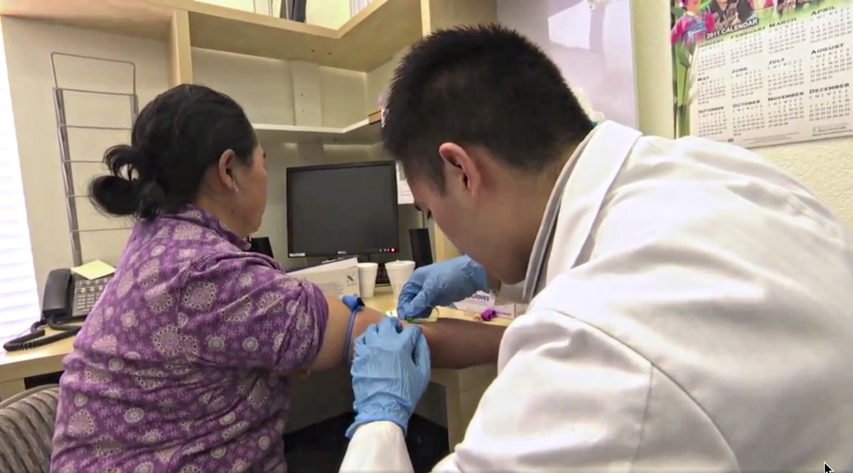 Thumbnail of investigating genetic contributors to Asian American liver cancer disparities - UC Davis Medical doctor getting blood samples from a patient